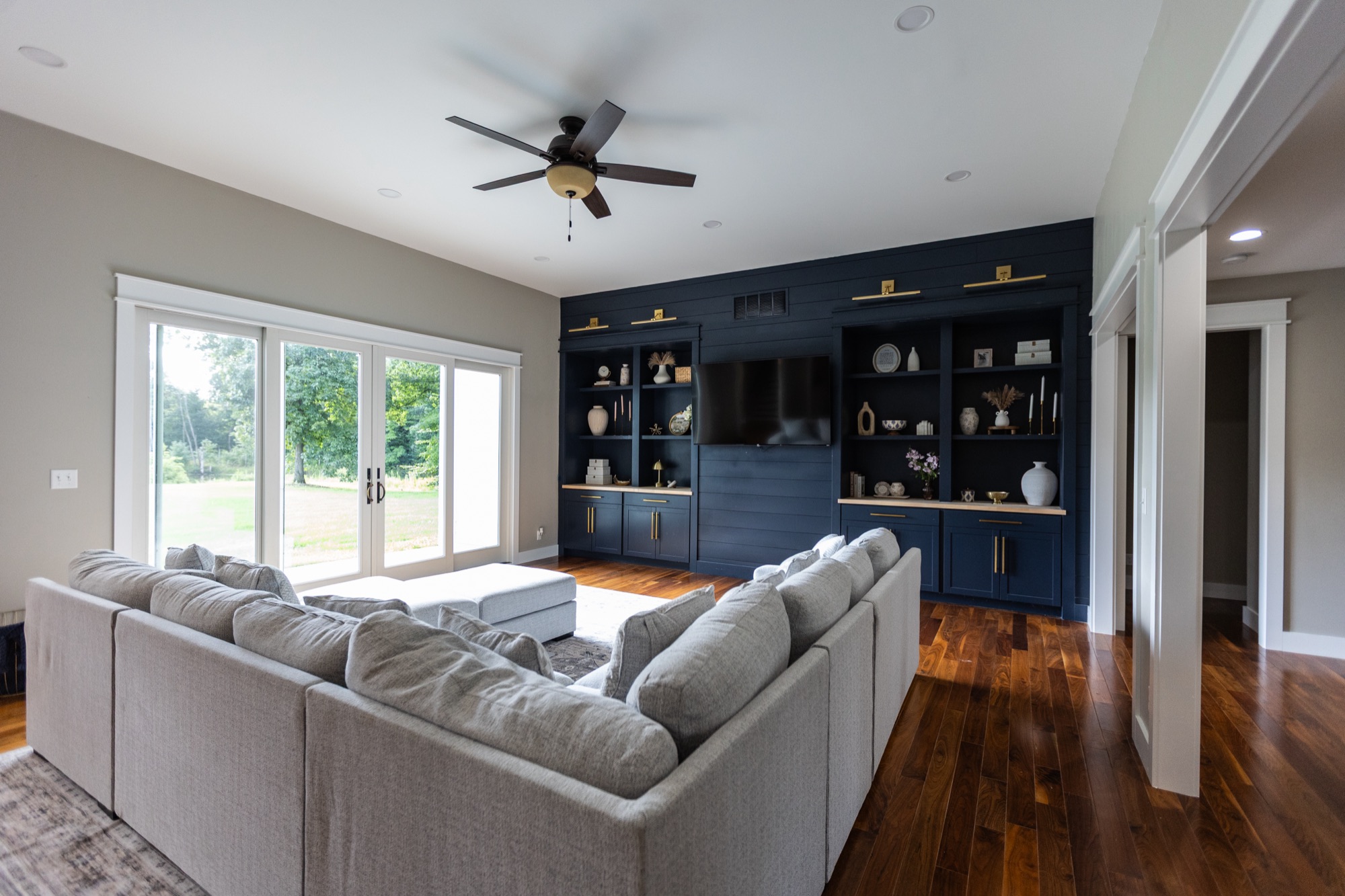 Living room at Lakeside Manor with sectional sofa and built-in shelving