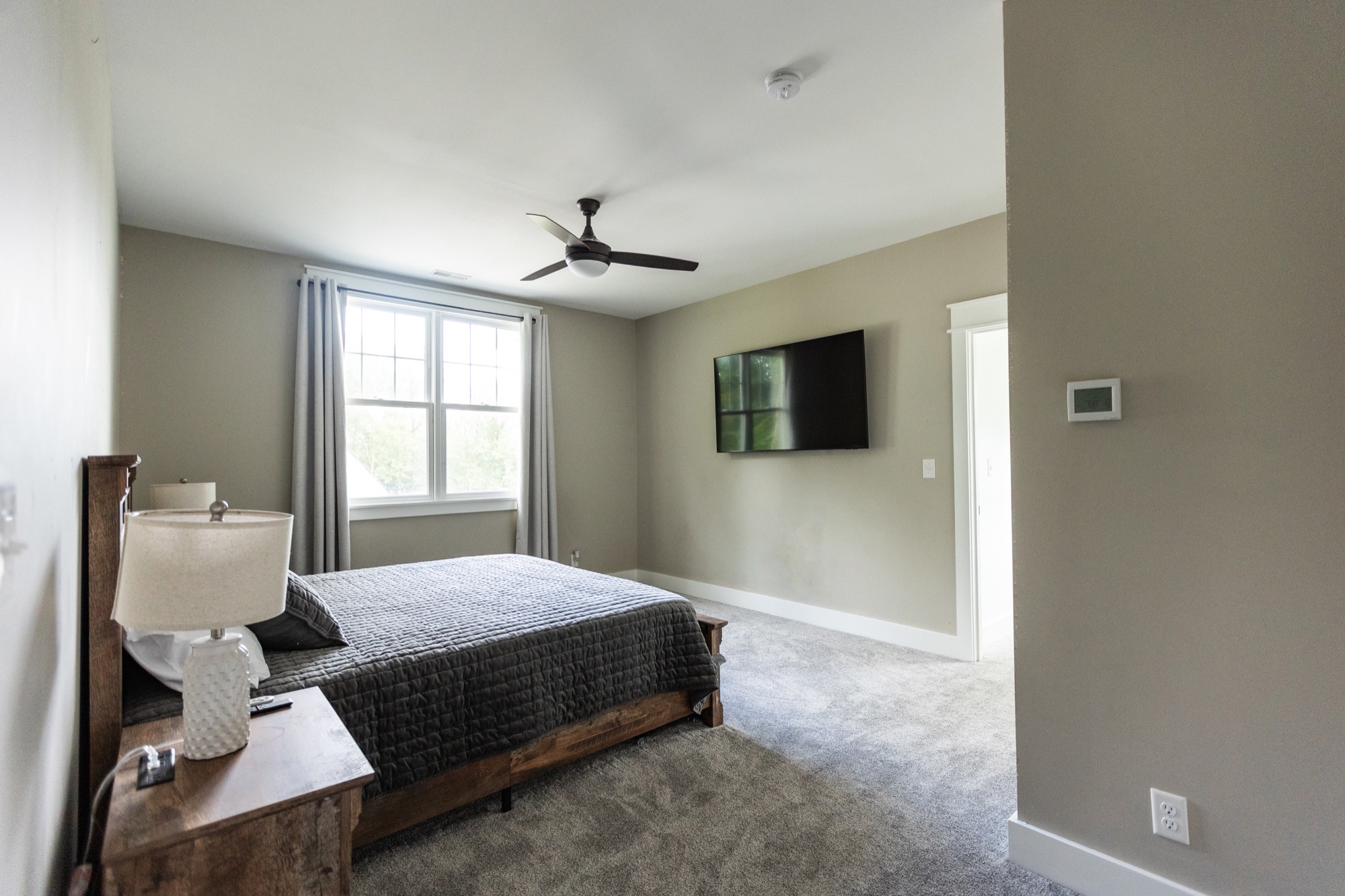 Bedroom at Lakeside Manor with king bed and mounted TV