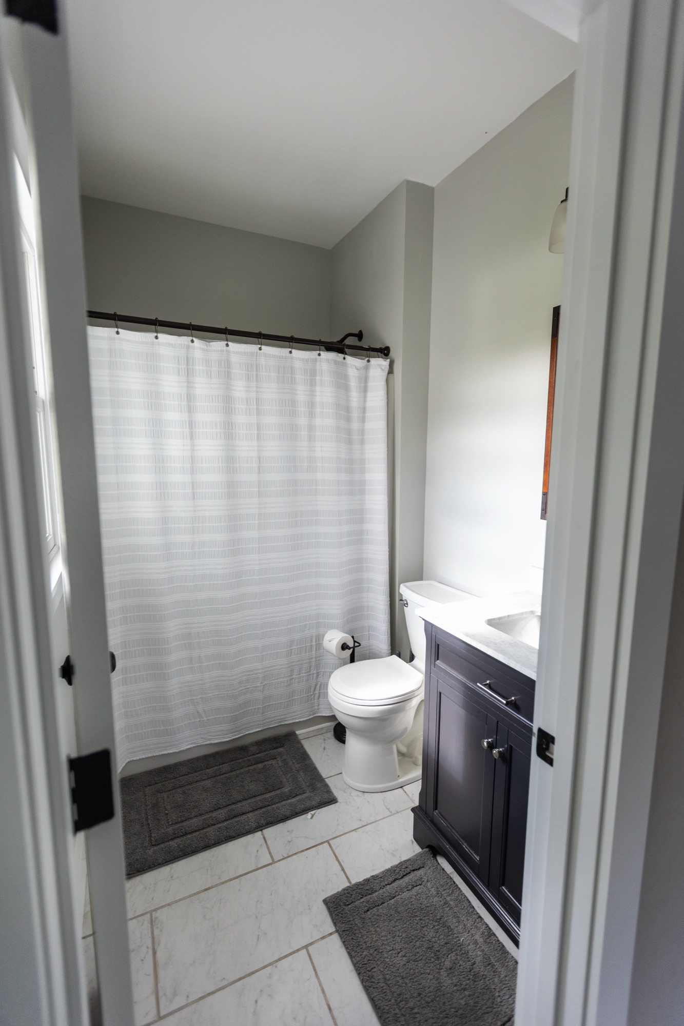 Bathroom at Lakeside Manor with shower and dark vanity