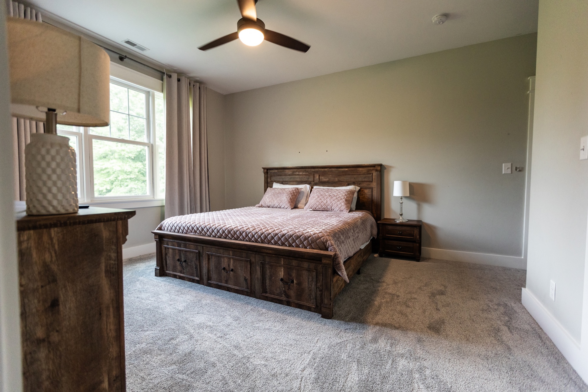 Bedroom at Lakeside Manor with a dresser and mounted TV