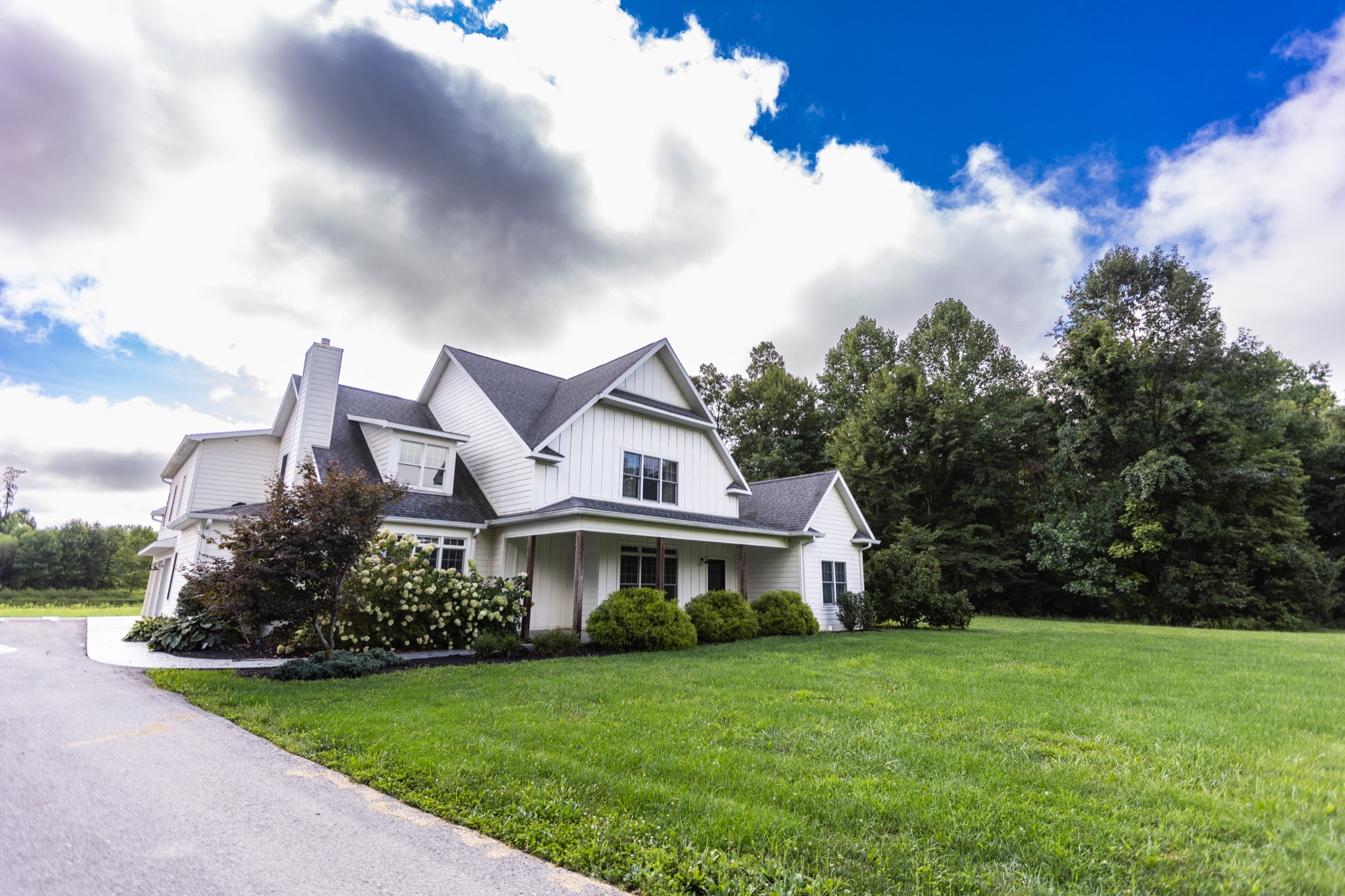 Lakeside Manor exterior at Abram Farms, driveway and front lawn