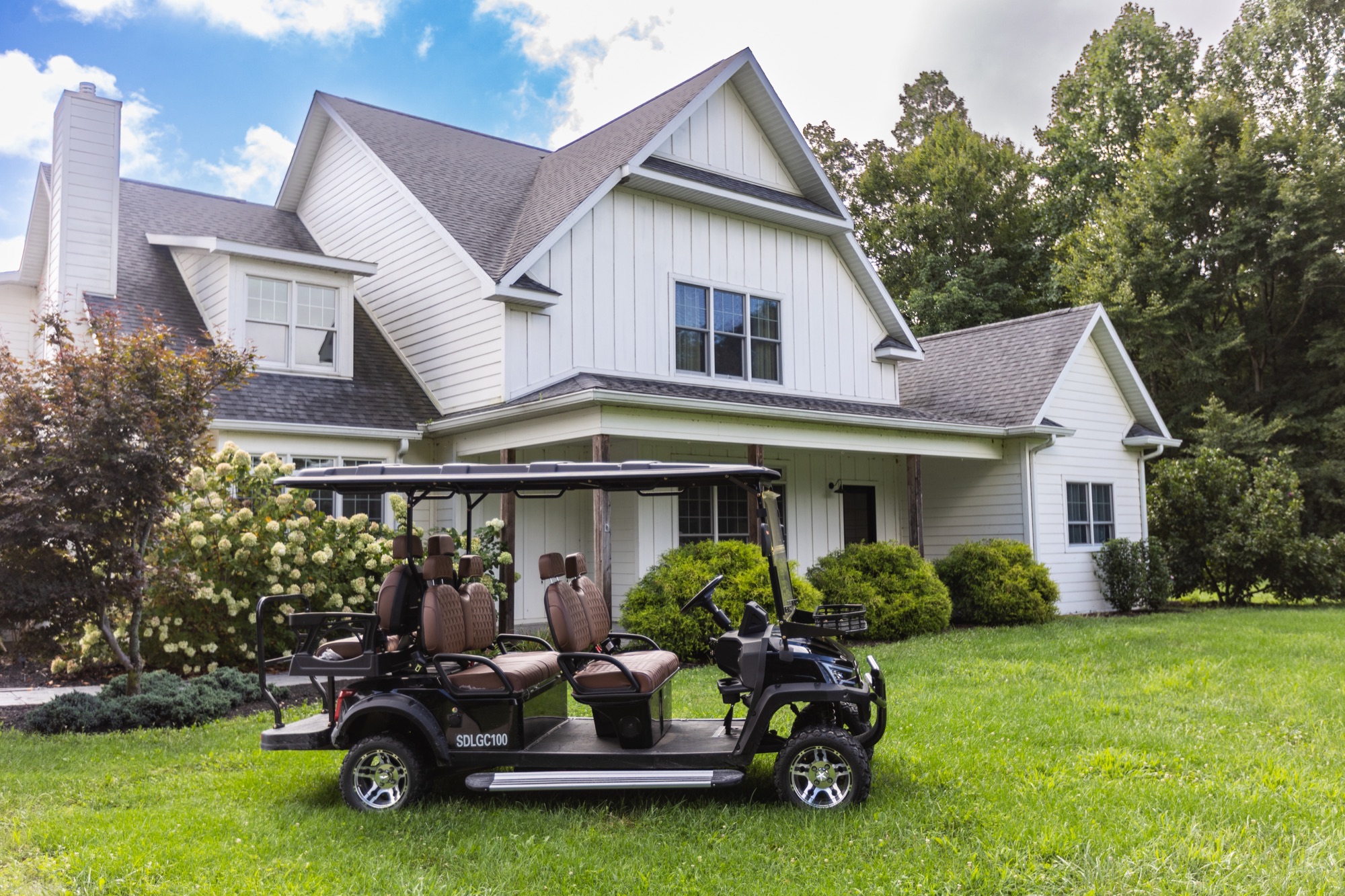 Lakeside Manor exterior at Abram Farms, with the golf cart parked out front