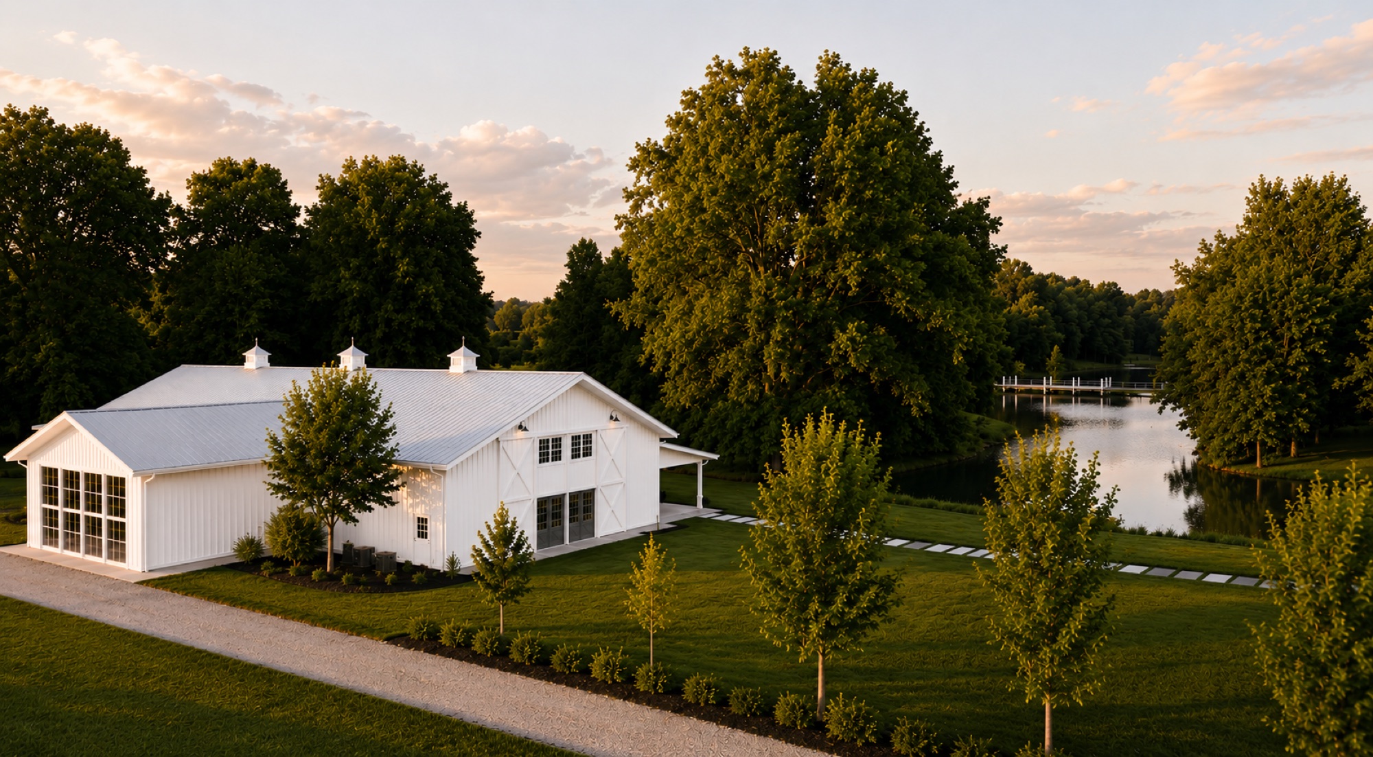 Aerial rendering of the 2027 white barn exterior at Abram Farms, with the pond and grounds